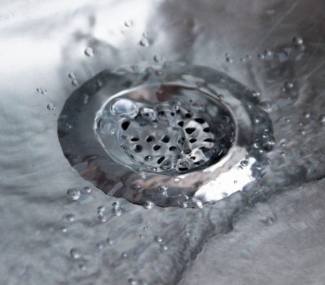 Close up of a metallic silver drain strainer — Blocked Drain Services In Gold Coast, QLD