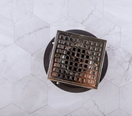 Drain cover floor drain from modern shower — Blocked Drain Services In Helensvale, QLD