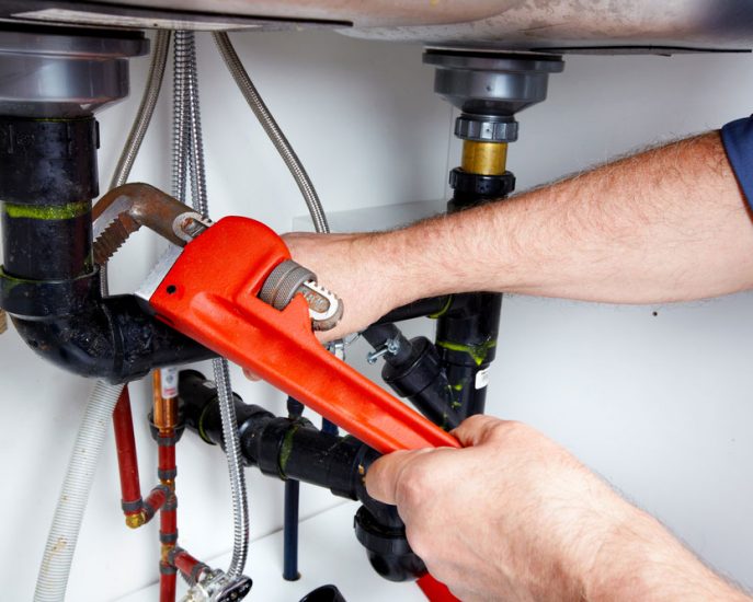 Hands of Professional Plumber — Blocked Drain Services In Palm Beach, QLD