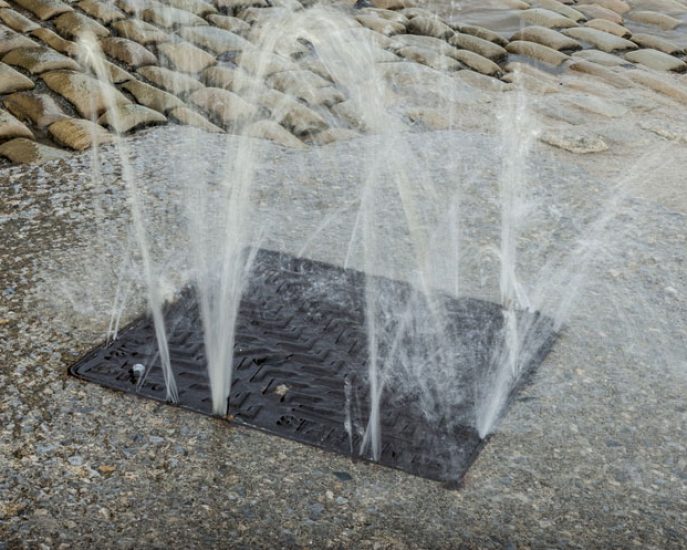 Water bursting from a drain — Blocked Drain Services In Burleigh Heads, QLD