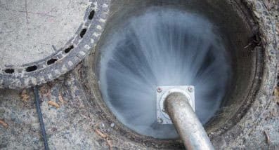 Pouring Water in Manhole for Stormwater Drain Repairs | Gold Coast Blocked Drains